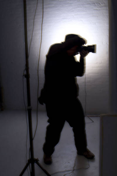 Photographer silhouetted by strobes